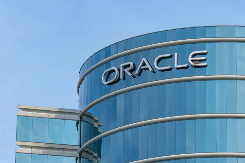 Oracle Corporation's headquarters building with the company's logo prominently displayed on reflective blue glass windows