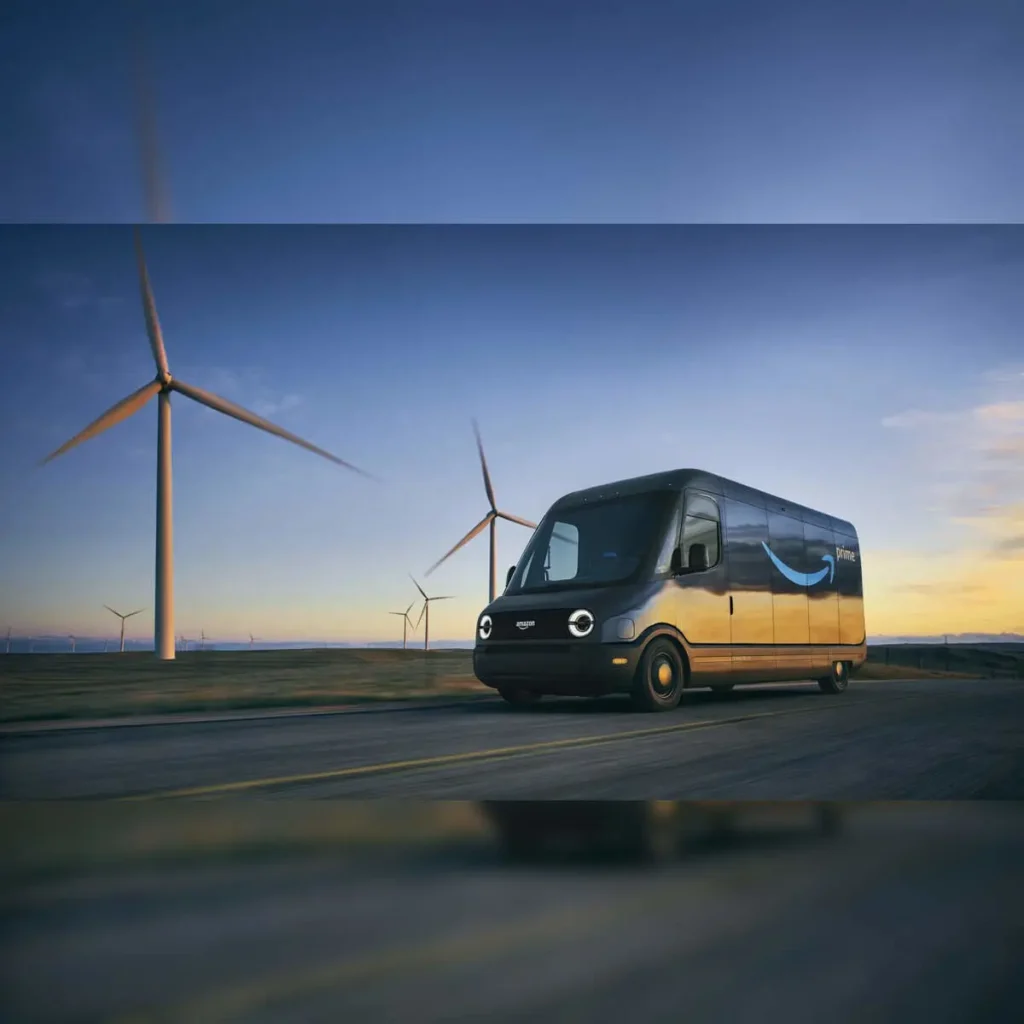 Rivian electric delivery van for Amazon fleet driving near wind turbines symbolizing sustainable logistics