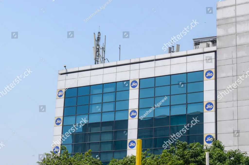 Reliance Jio corporate building with Jio logos on facade and communication antennas on the roof 