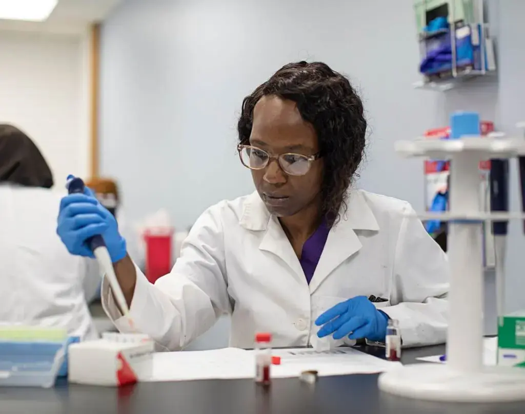 Medical laboratory scientist conducting precise research in a pharmaceutical lab setting 