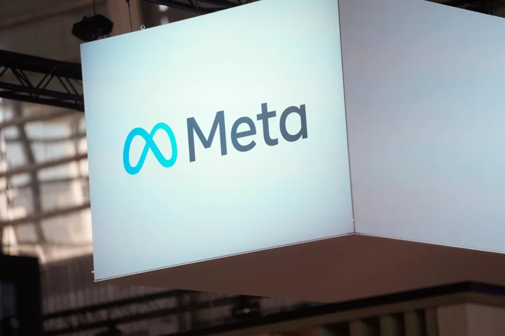 Meta logo displayed on a large hanging sign at an indoor event