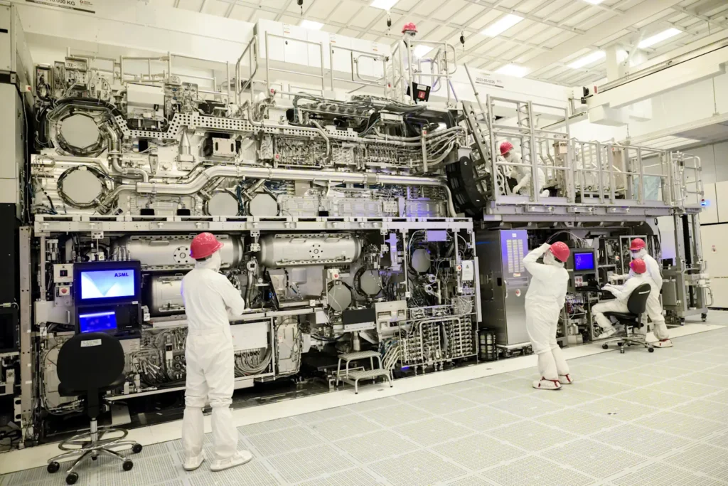 Technicians operating an advanced ASML EUV lithography machine in a semiconductor cleanroom environment newsroom.intel
