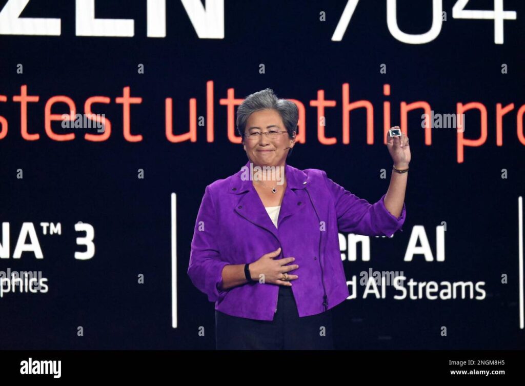 AMD CEO showcasing a Ryzen 7040 series chip during a product launch presentation