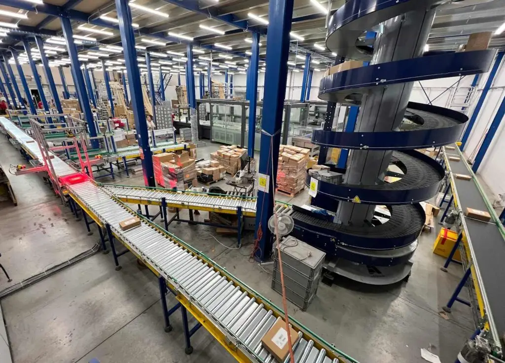 Inside an Amazon fulfillment center showing conveyor belts and automated parcel handling systems