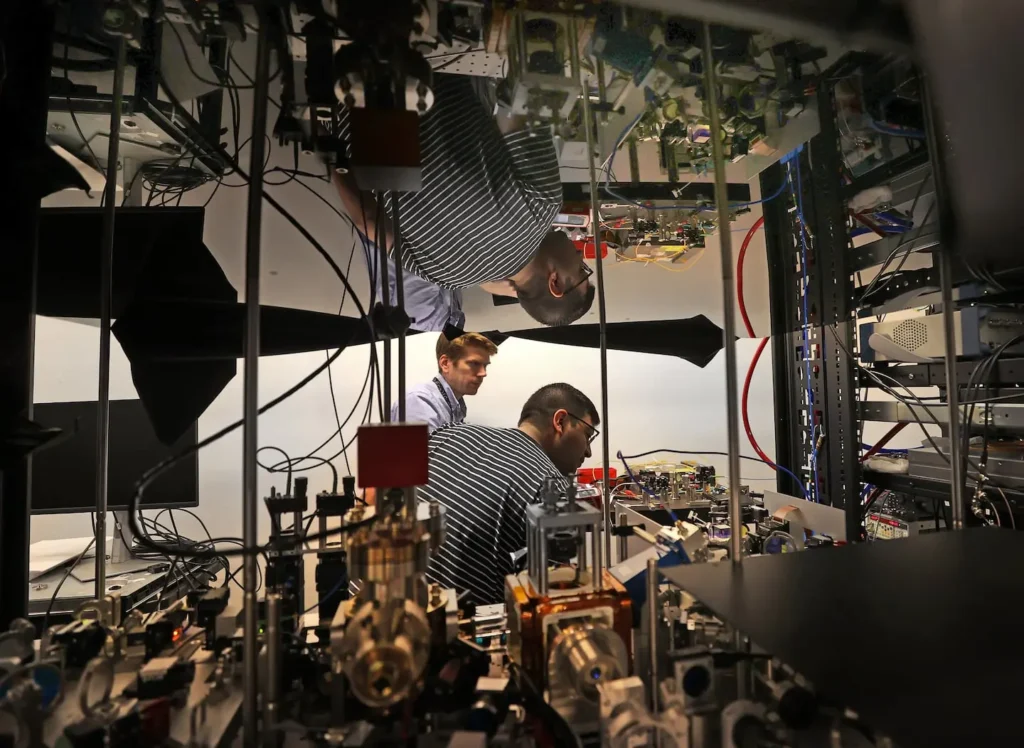 Engineer working on complex quantum computing equipment in a high-tech laboratory environment 