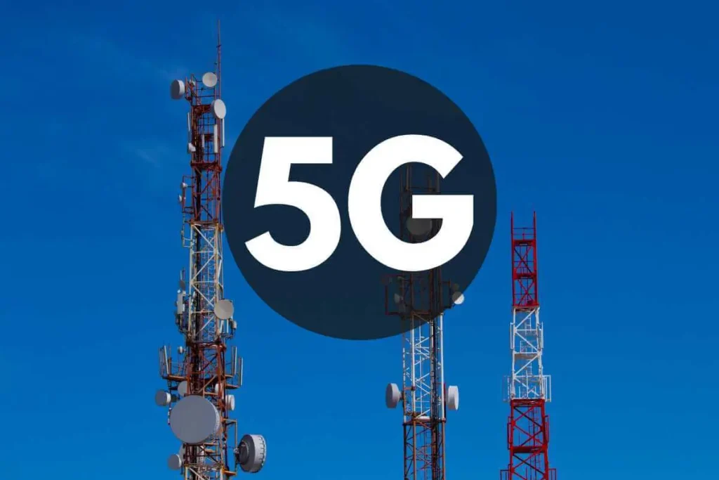 Telecommunications towers equipped for 5G wireless technology set against a clear sky