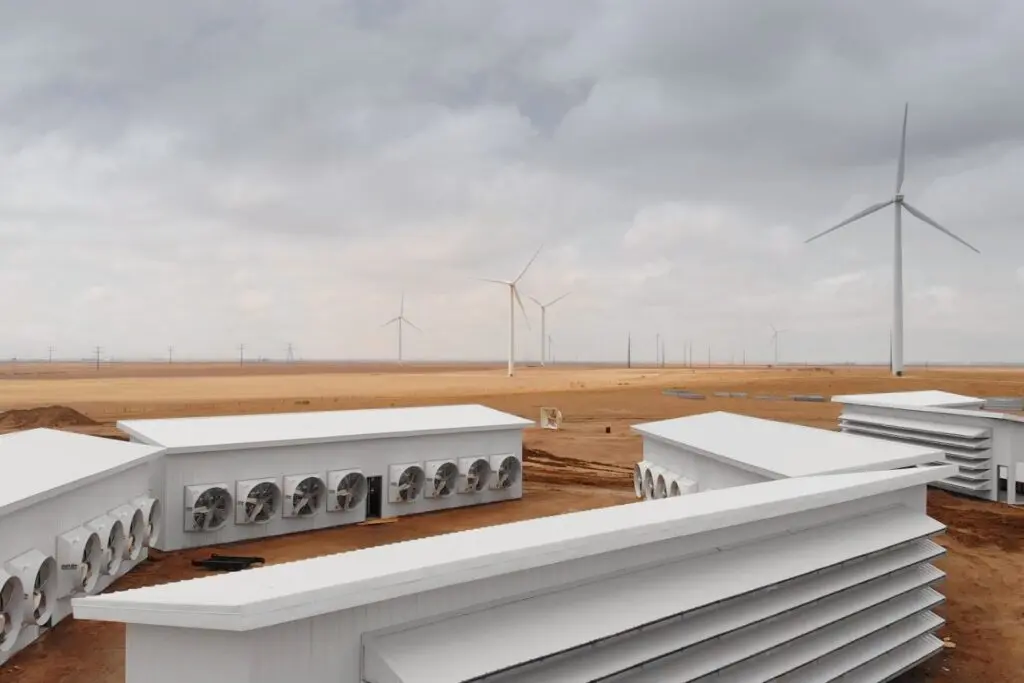 Modern Bitcoin mining data center powered by renewable wind energy with cooling infrastructure in a desert setting 