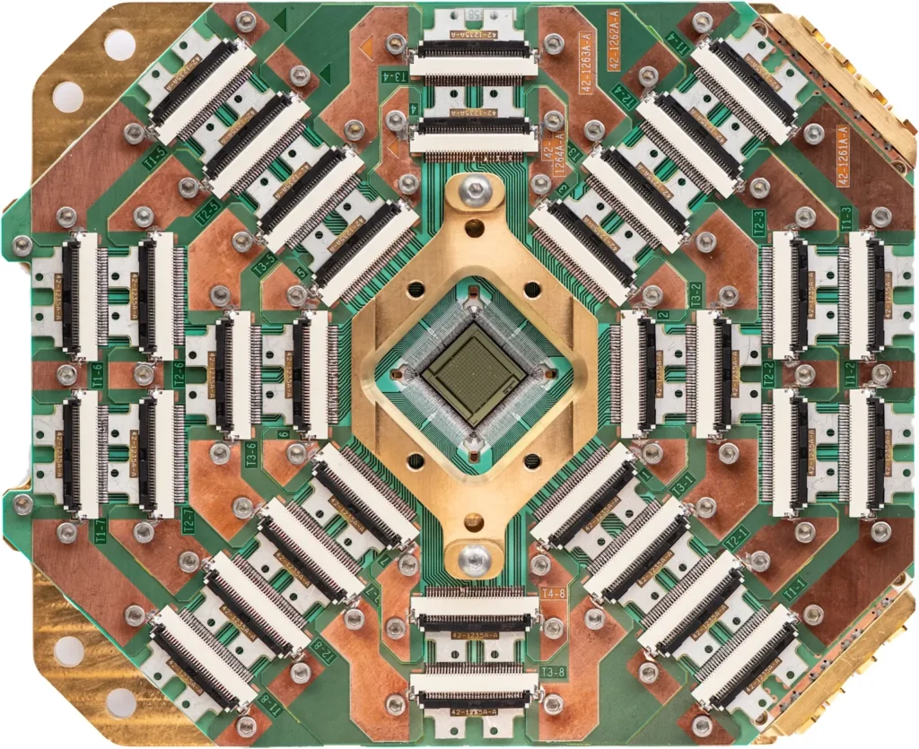 Top-down view of the D-Wave Advantage quantum annealing chip, showcasing the complex circuitry and connectors of this advanced quantum processor 