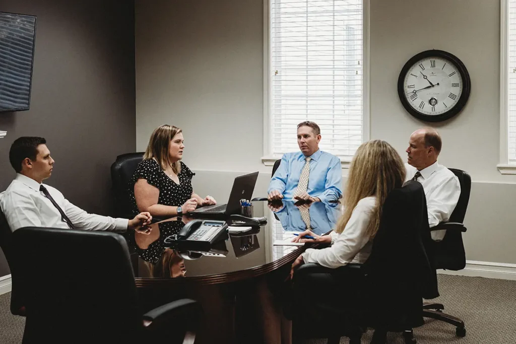 Financial advisors meeting in a professional setting, discussing investment management strategies 