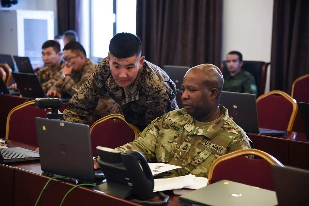 Military personnel engaged in technology training, illustrating the application of AI and data analytics in defense operations 