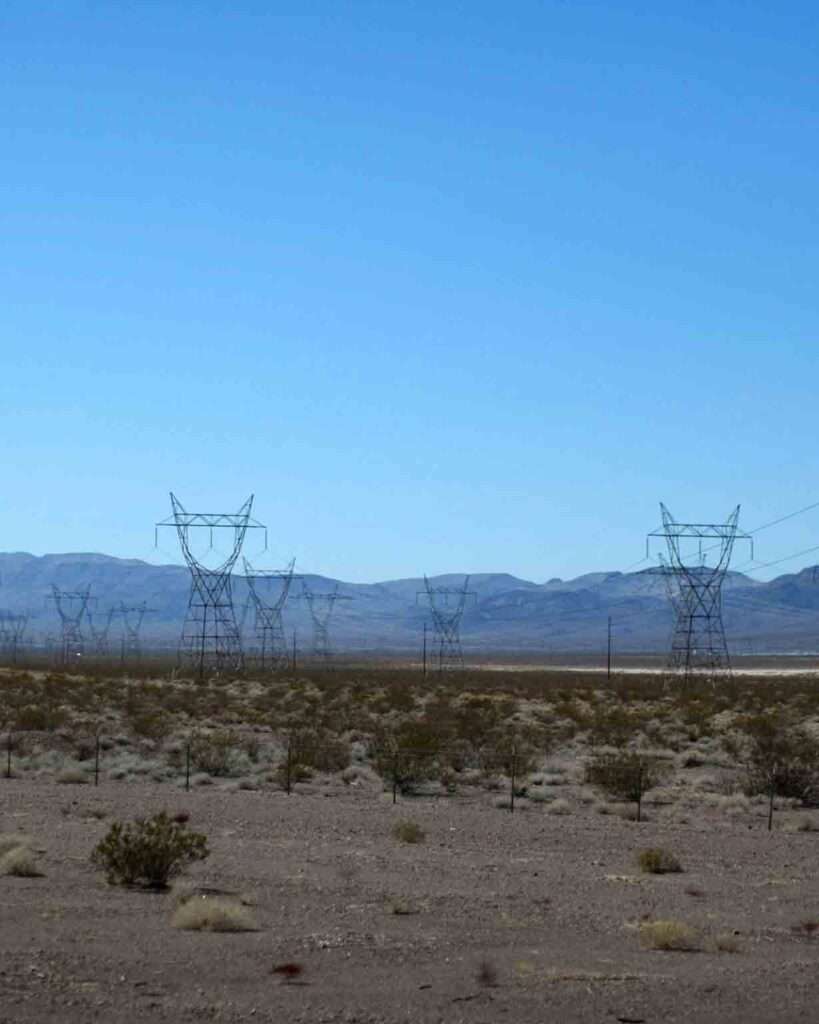 High-voltage electricity transmission towers in the Nevada desert, illustrating power distribution infrastructure relevant to NV Energy 