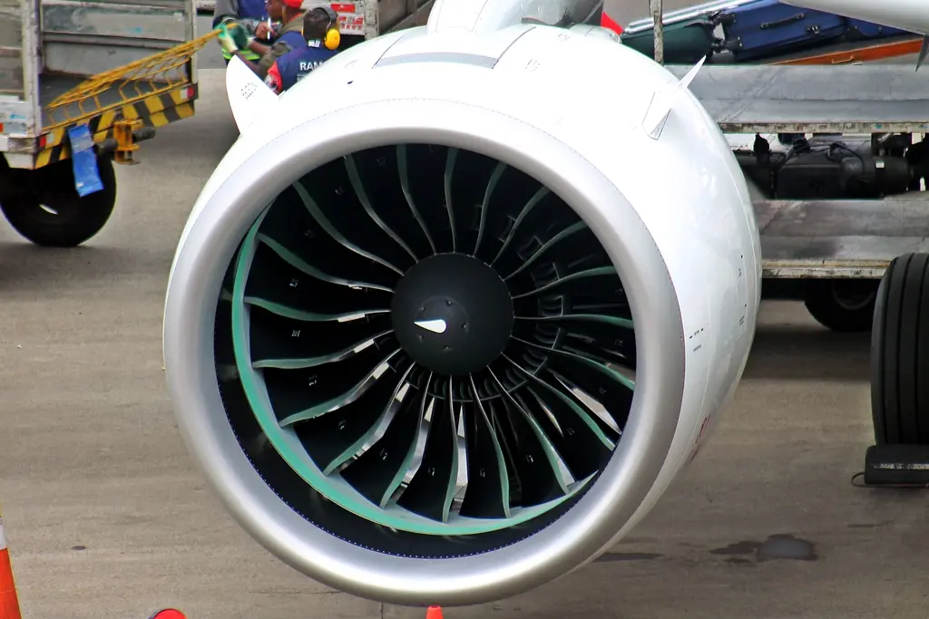 Close-up view of a Pratt & Whitney PW1000G turbofan engine showcasing its fan blades and engine intake 