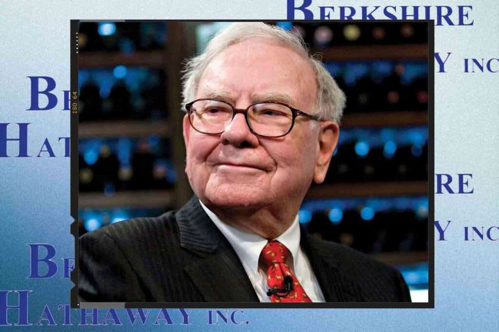 Businessman in suit sitting in front of shelves with bottles, linked to Berkshire Hathaway Inc 
